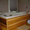 Whirlpool tub with wood front panel